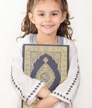 little girl is happy to learning QUran